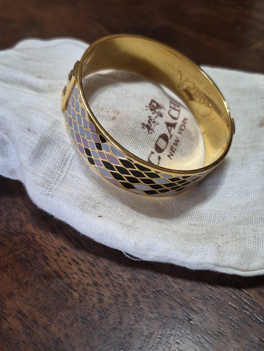 Coach Gold Tone Enamel Bangle Bracelet with Black and Pale Pink Pattern